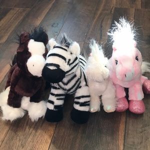 Four webkinz: two horses, one unicorn and pegasus